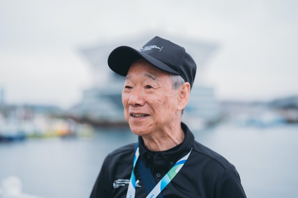 a man wearing a triathlon medal